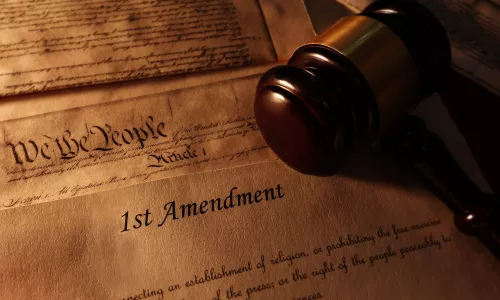 First Amendment and US Constitution historic documents with legal gavel